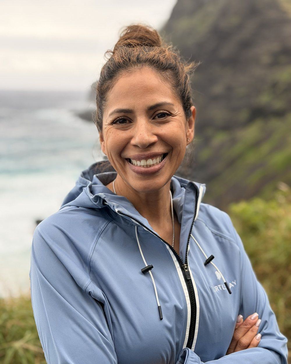 Elvia smiling by the ocean